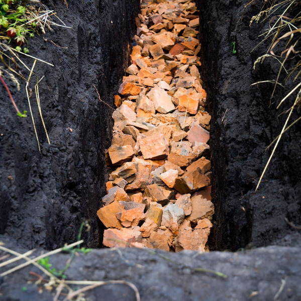 A French drain made with broken bricks.